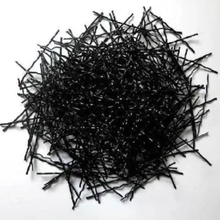 A pile of black crimped macro synthetic fibers