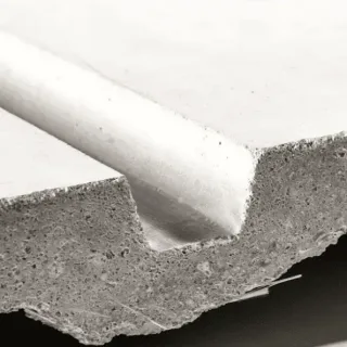 Cut edge of a glass fiber reinforced concrete panel next to a coarser concrete section