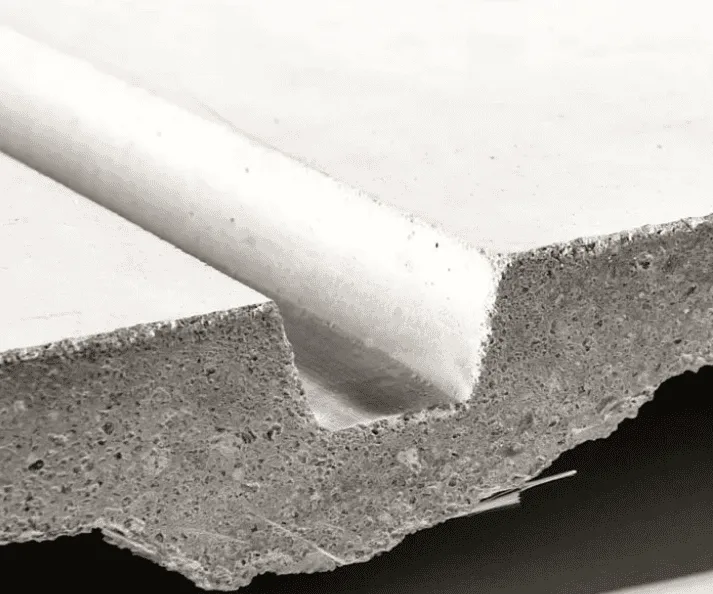 Cut edge of a glass fiber reinforced concrete panel next to a coarser concrete section