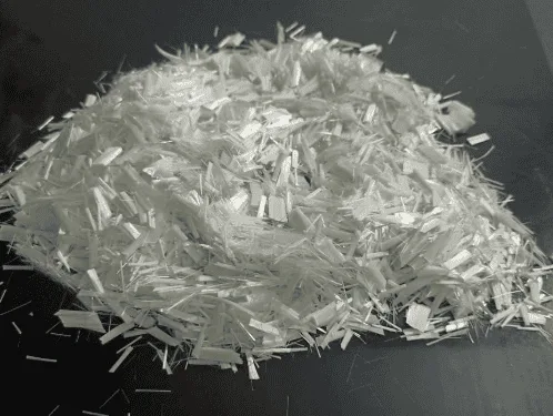 A pile of chopped fiberglass strands on a dark background